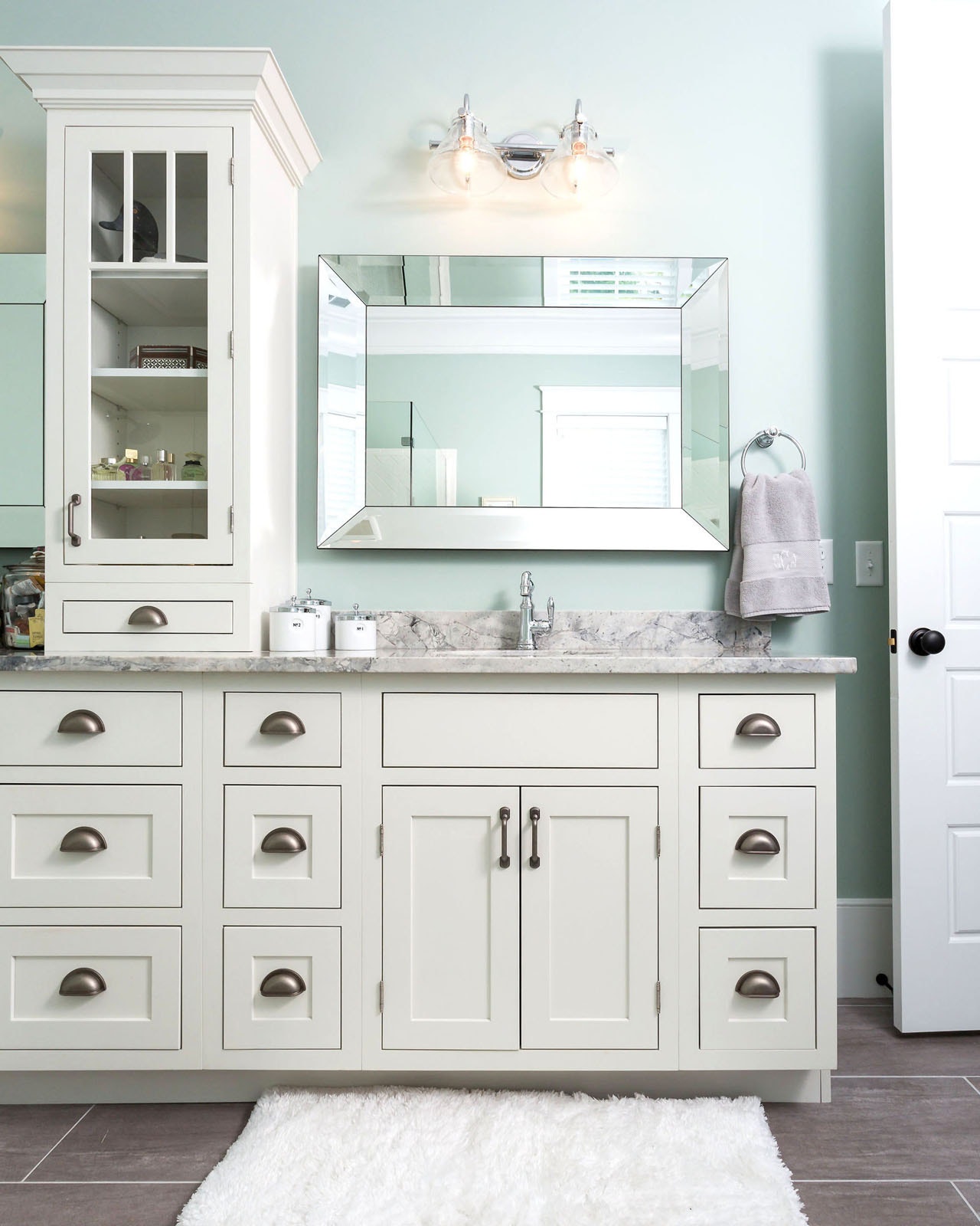 CliqStudios bath cabinets shown in Austin White door style and finish